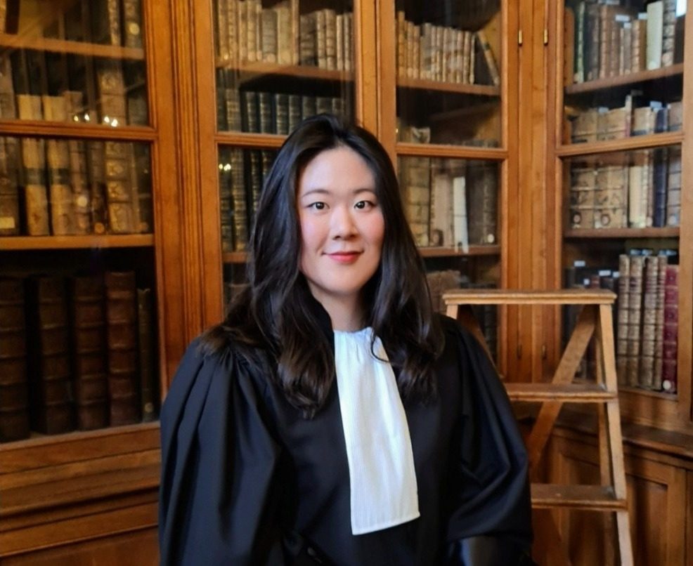 Habbine Estelle Kim in her lawyer’s gown in a library