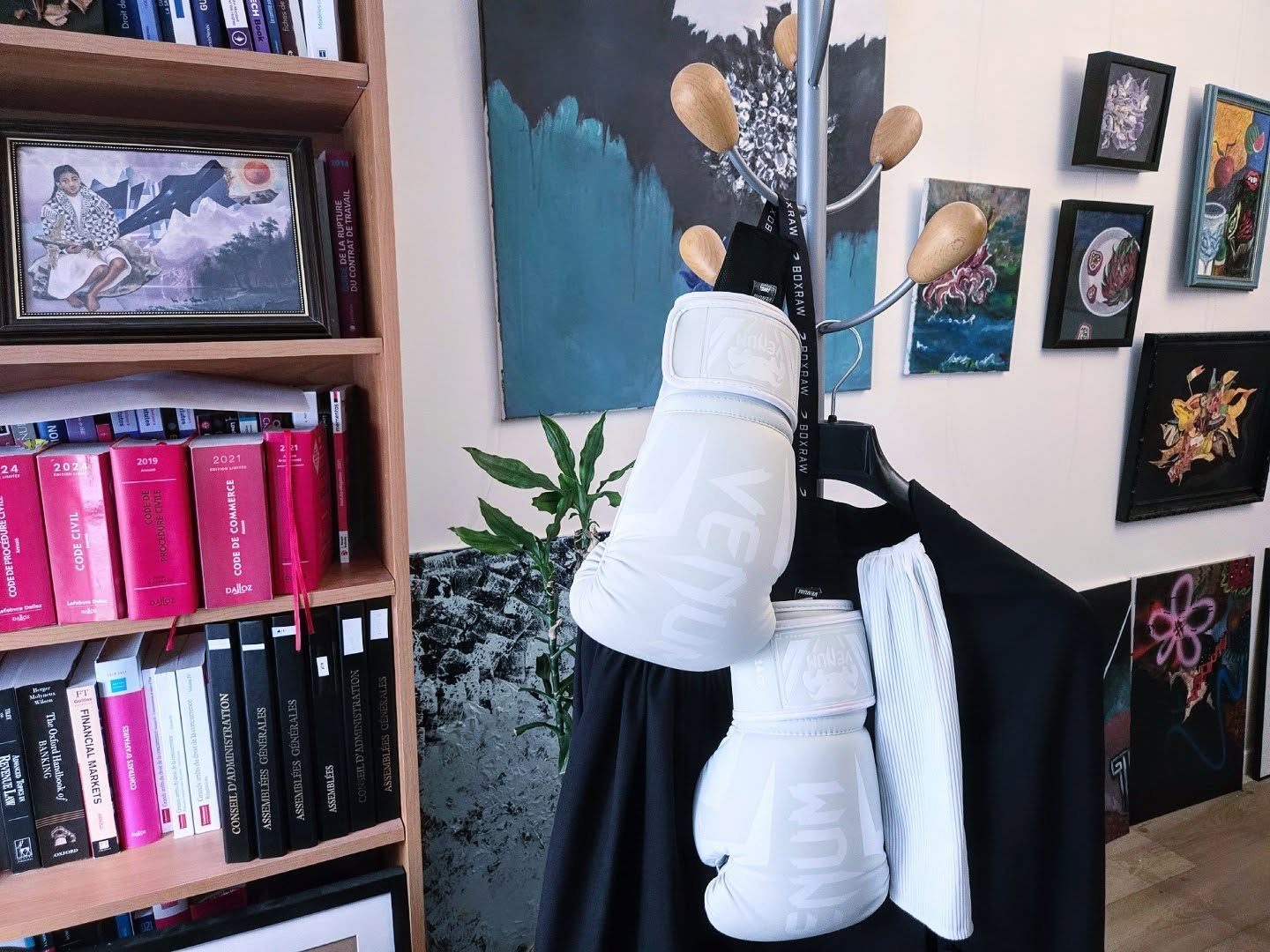 Lawyer’s gown and white boxing gloves on a coat stand
